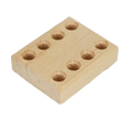 Light-colored wooden pliers holder pegboard tool organizer with eight circular holes arranged in two rows of four
