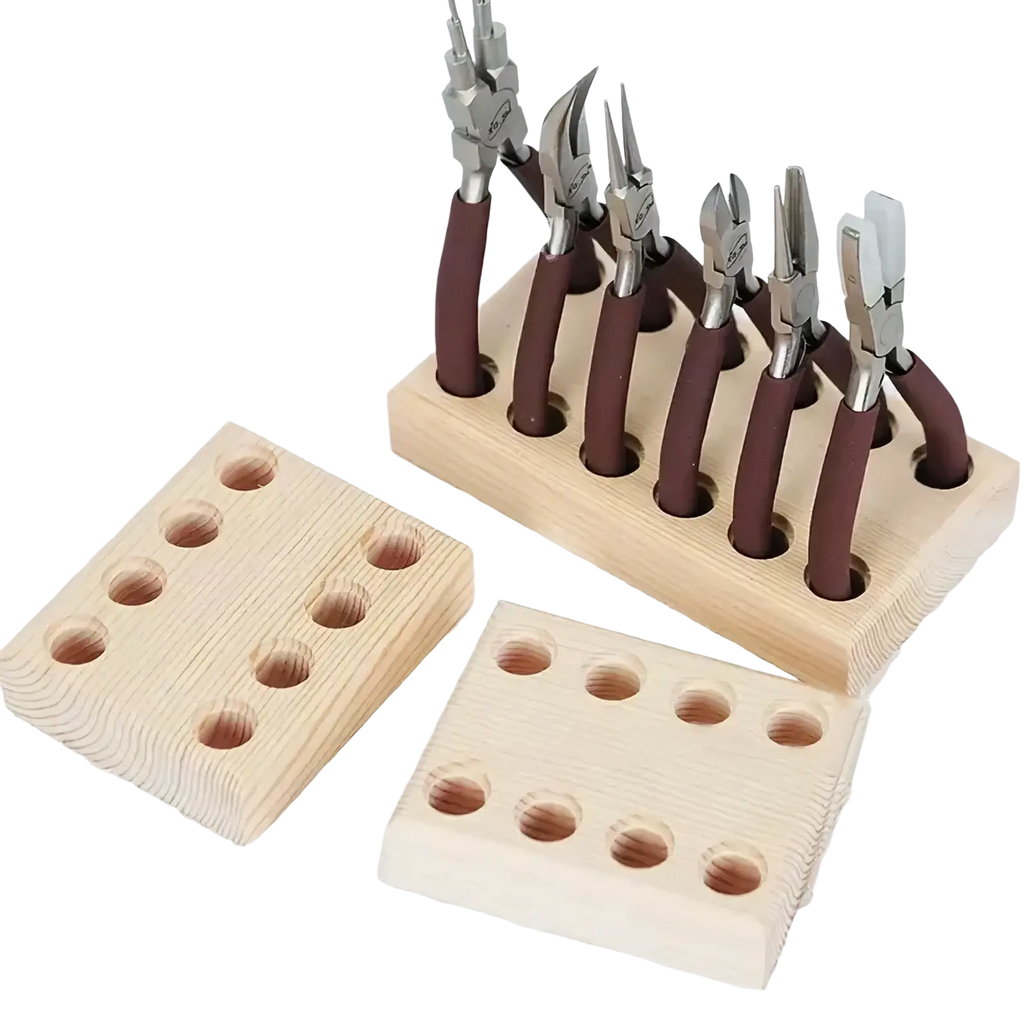 Set of six jeweler’s pliers with brown rubberized handles and silver metal heads neatly arranged in wooden pegboard holder