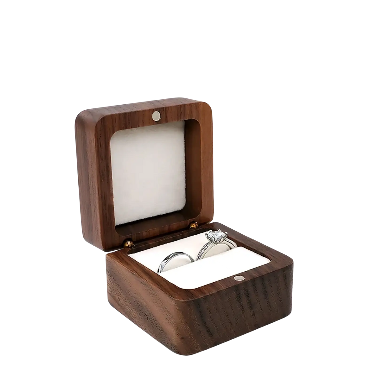 Beige wooden ring box with square design and soft white interior holding two rings for engagement proposals