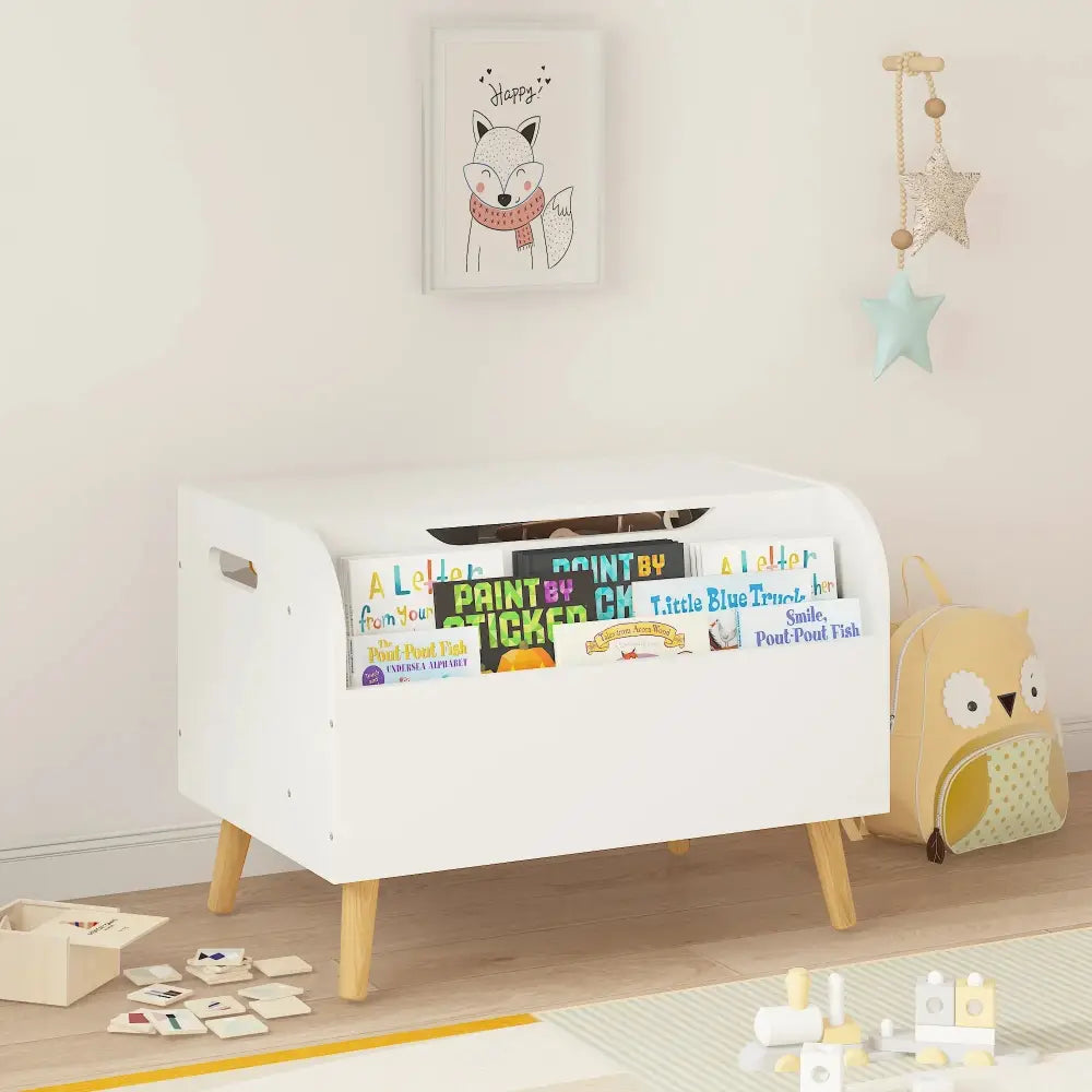 White wooden toy box and bookshelf bench with safety hinge featuring light wood legs and colorful children’s books in open slots