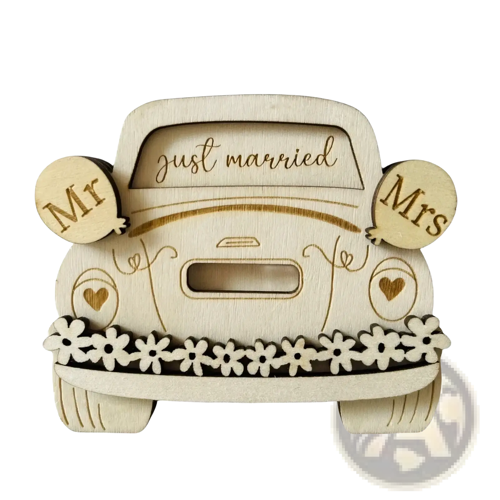 Light-colored wooden car-shaped money box with just married engraving and mr mrs balloon cutouts for wedding gifts