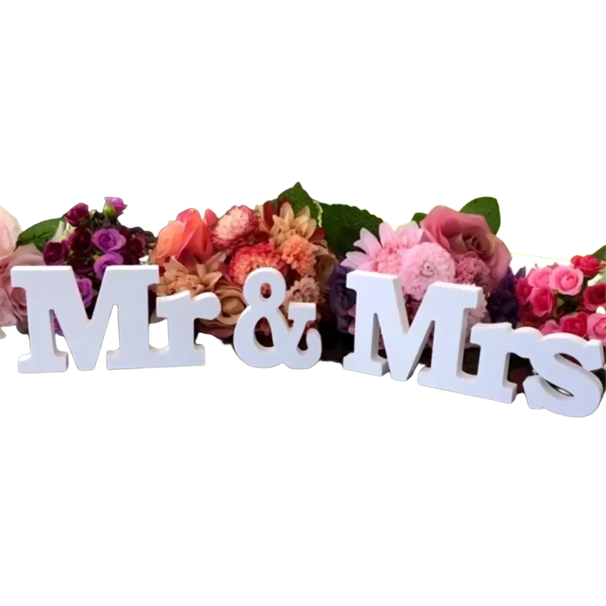 White wooden mr and mrs wedding table sign with glossy finish on reflective surface and colorful floral decor