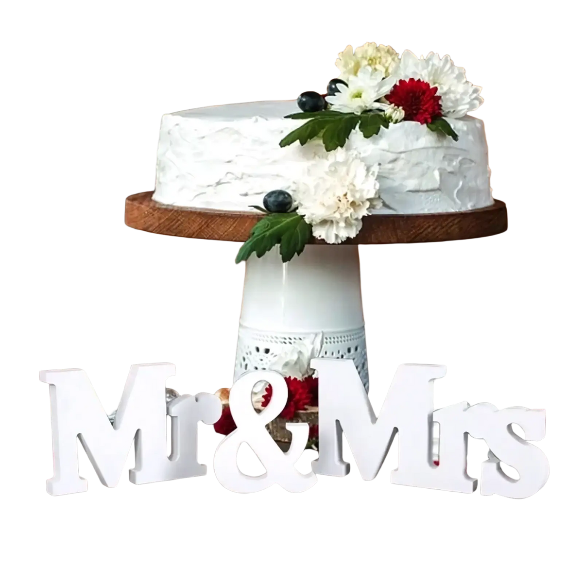 A white frosted cake with textured icing and red and white flowers next to a wooden wedding table sign mr and mrs decor