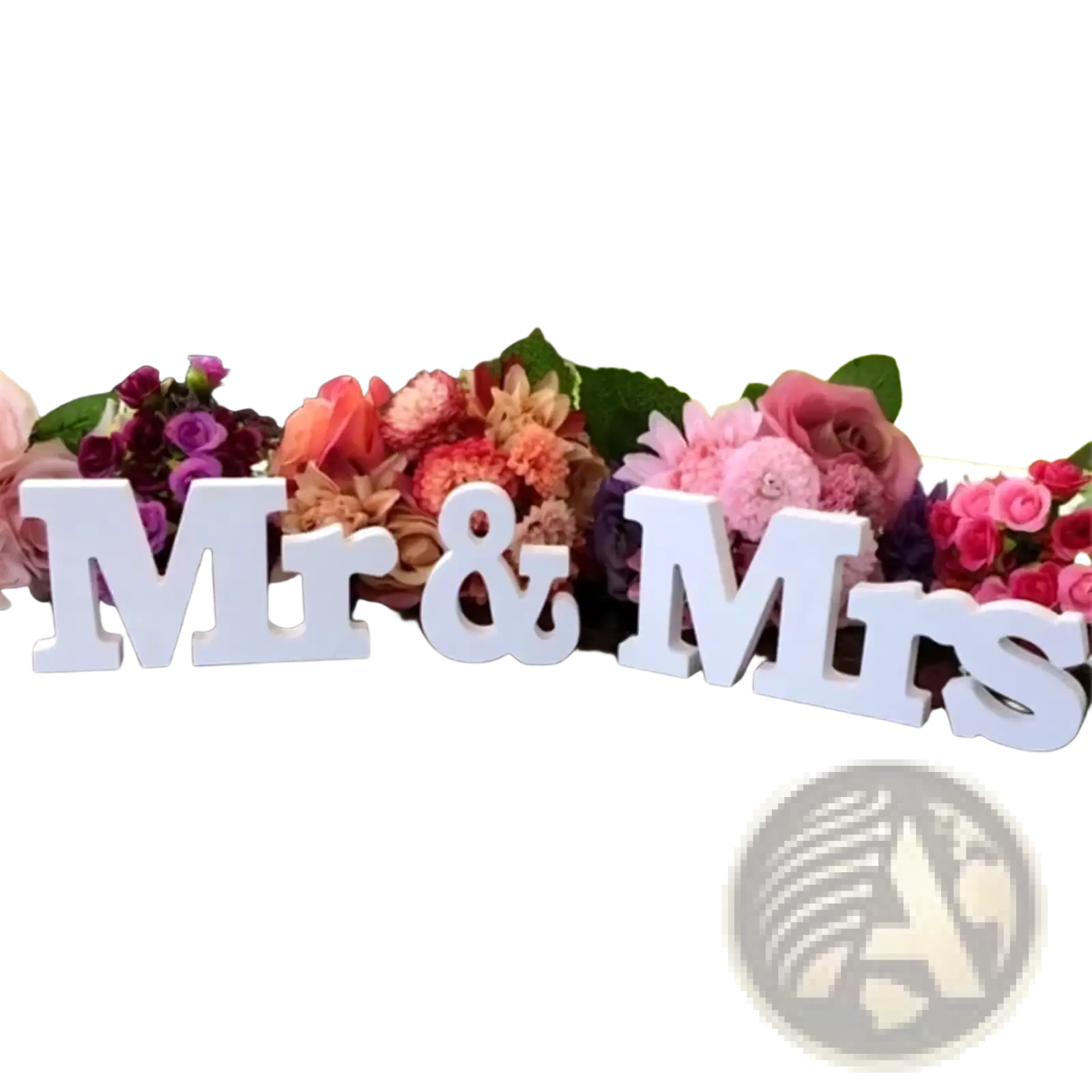 White wooden mr and mrs wedding table sign with glossy finish on reflective surface and colorful floral decor