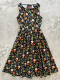 A sleeveless dark navy cotton 1950s style midi dress with vibrant pink rose woodland print and pockets