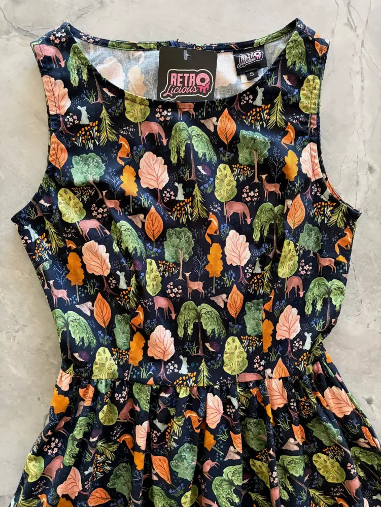 Woodland print navy cotton 1950s style sleeveless midi dress with pockets featuring forest trees deer and autumn leaves
