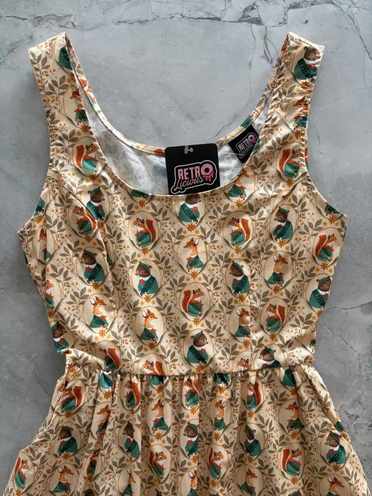 Woodland Scout vintage cotton sleeveless cream dress with squirrels in green outfits and leafy vine floral pattern