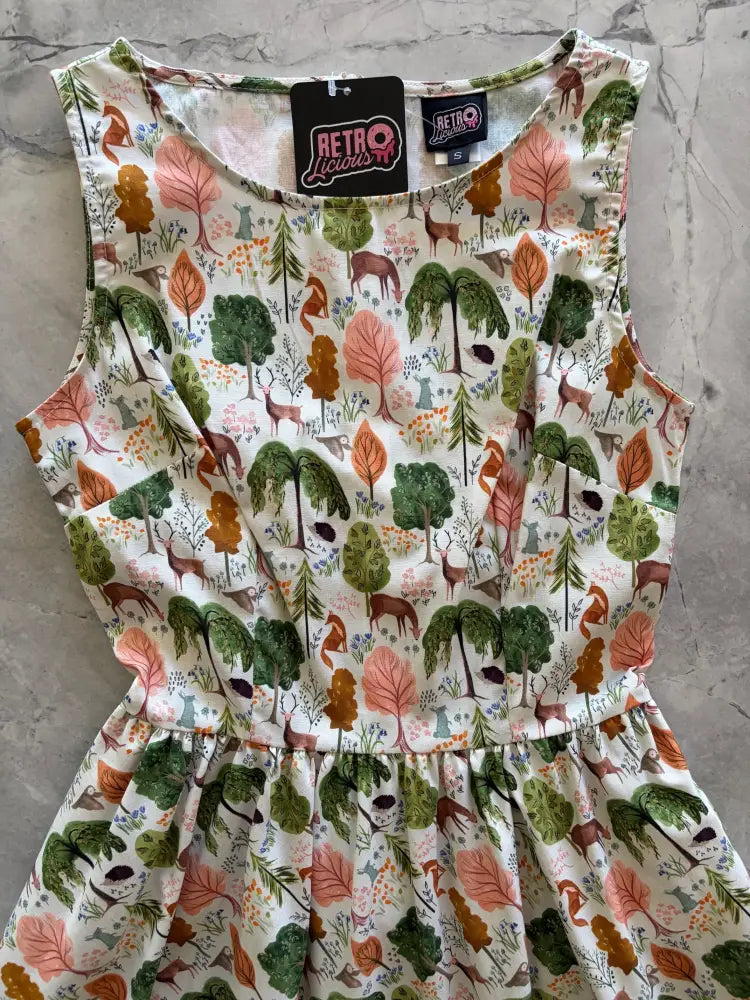Woodland vintage cream cotton sleeveless a-line dress with pockets featuring a whimsical forest print