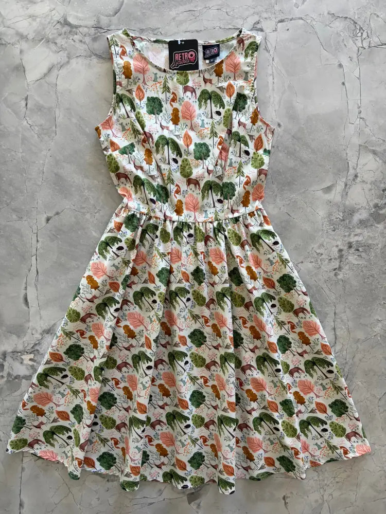 Woodland vintage cream cotton a-line dress with pockets featuring a sleeveless whimsical forest print
