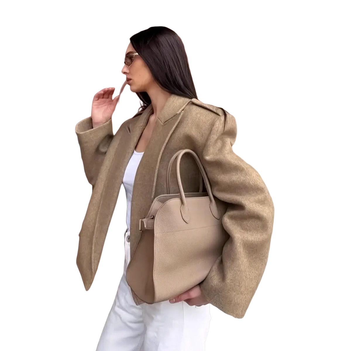 Beige leather handbag with structured shape and top handles paired with a wool blend winter coat