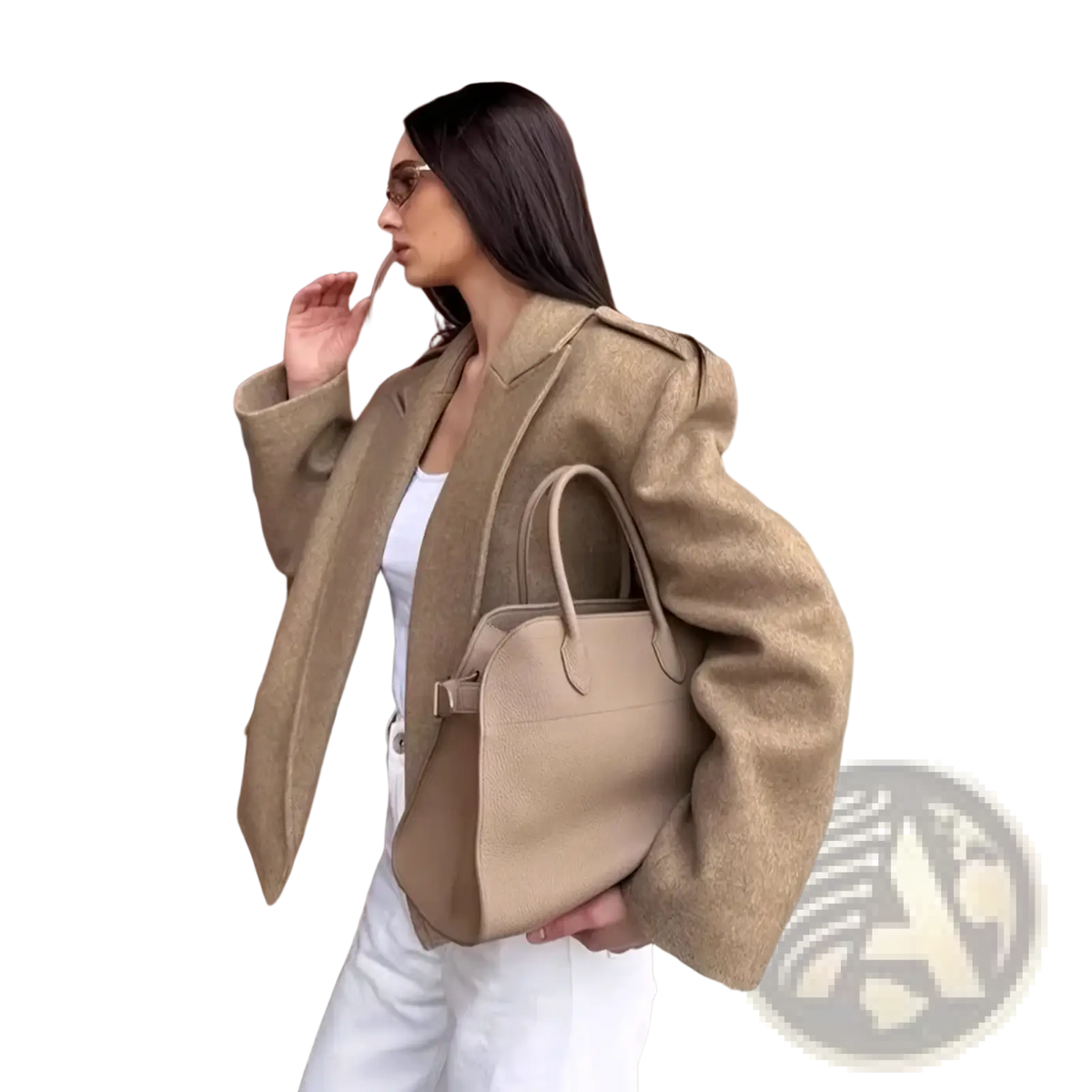 Beige leather handbag with structured shape and top handles paired with a wool blend winter coat