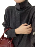 Dark gray wool button turtleneck sweater with soft knit texture and three matching buttons down the front