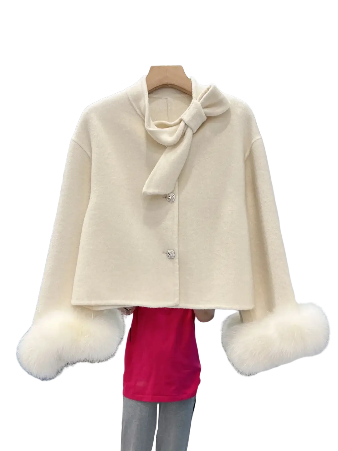 Cream-colored wool cropped coat with fluffy white fur cuffs and matching bow at the neckline