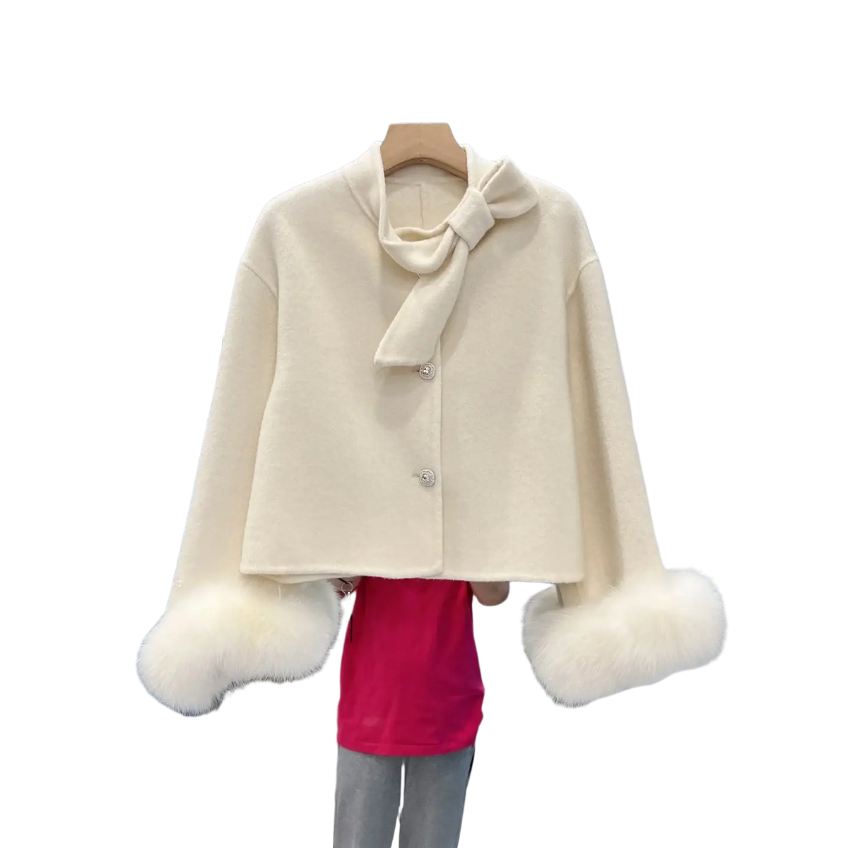 Cream-colored wool cropped coat with fluffy white fur cuffs and matching bow at the neckline
