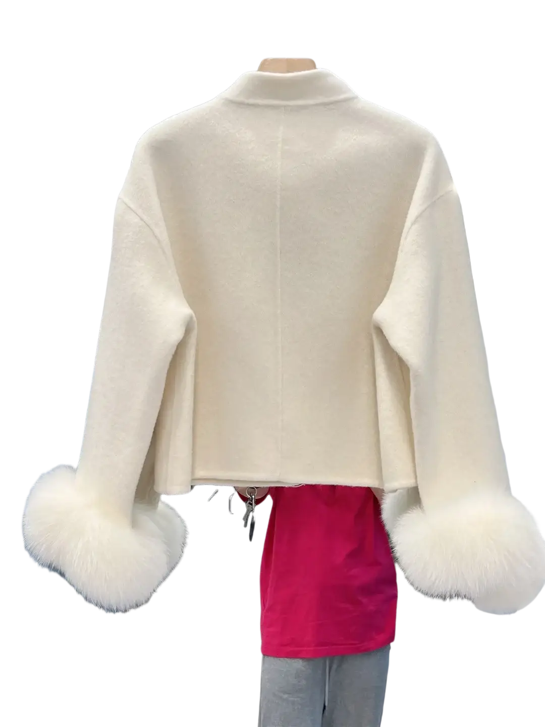 Cream-colored wool cropped coat with fluffy white fur cuffs and bow detail for stylish winter wear