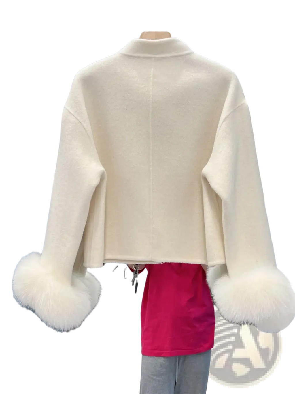 Cream-colored wool cropped coat with fluffy white fur cuffs and bow detail for stylish winter wear