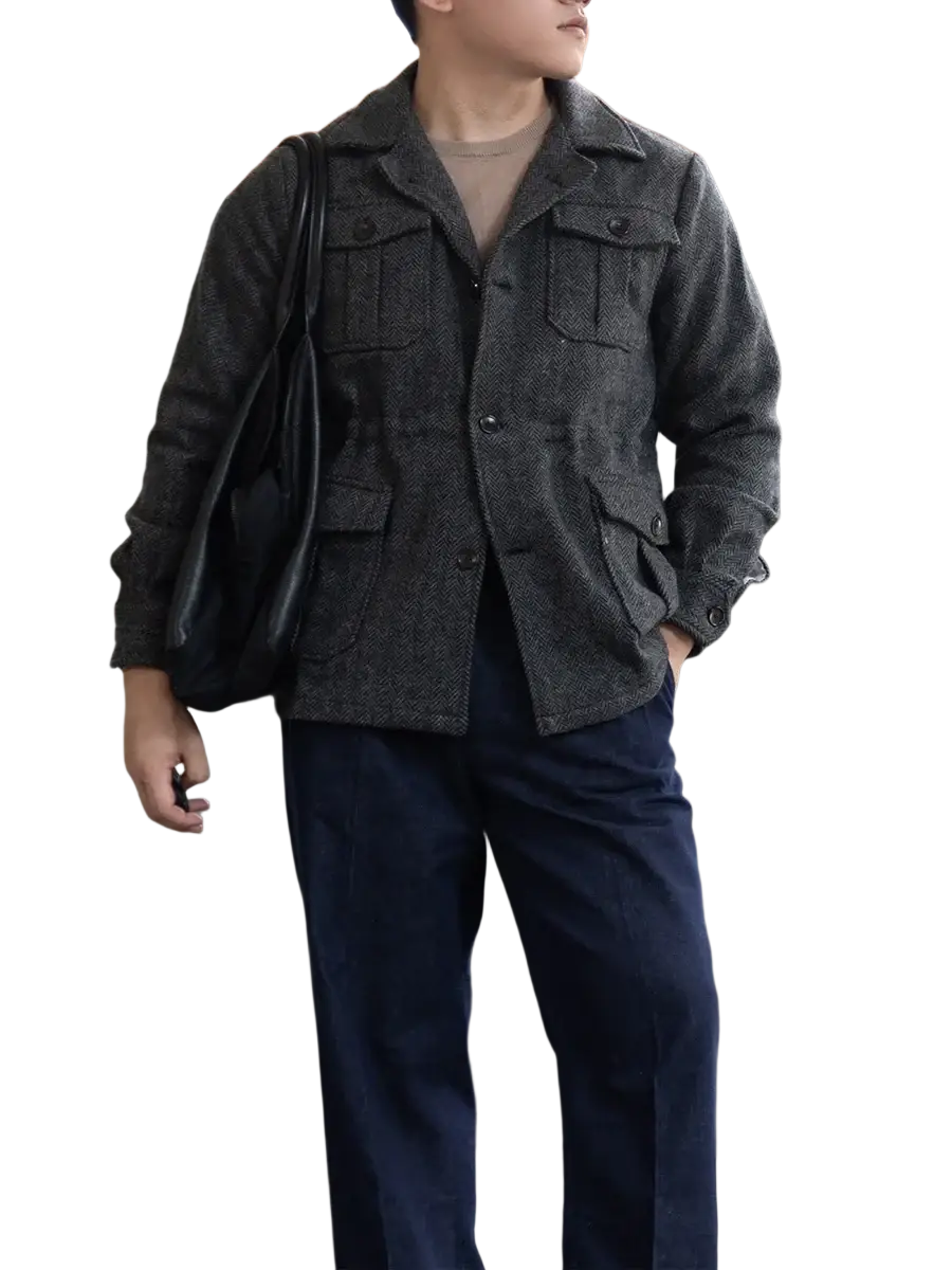 Dark gray wool herringbone hunting jacket for men with buttoned flap pockets and classic collar textured design