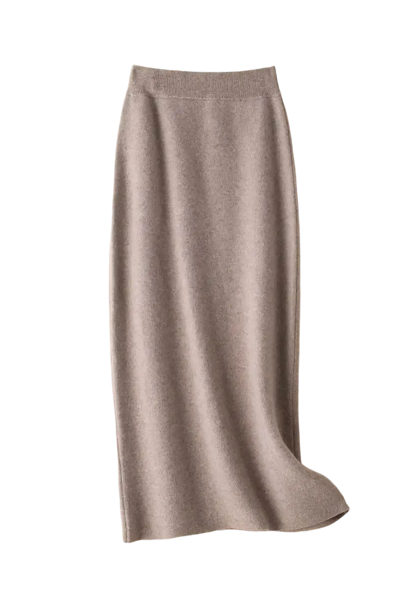 A soft muted gray wool knit midi skirt with ribbed waistband and smooth flowing fabric in a high waisted pencil style
