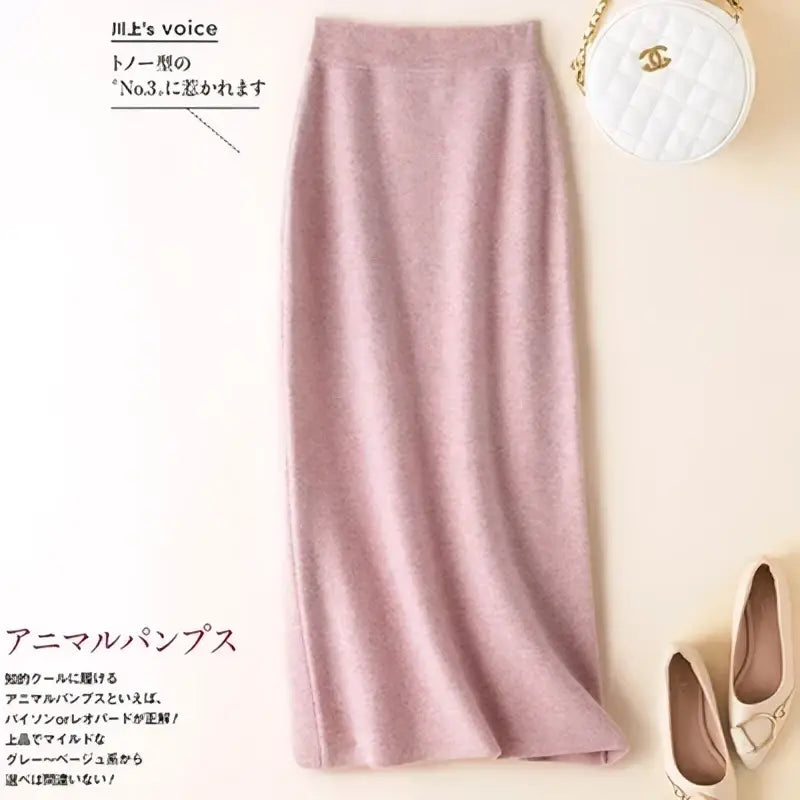 A soft pink wool knit midi skirt with a shimmering high waisted pencil silhouette and smooth flowing texture