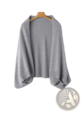 A soft light gray wool knit shawl scarf cardigan wrap with relaxed fit and wide sleeves on a wooden hanger