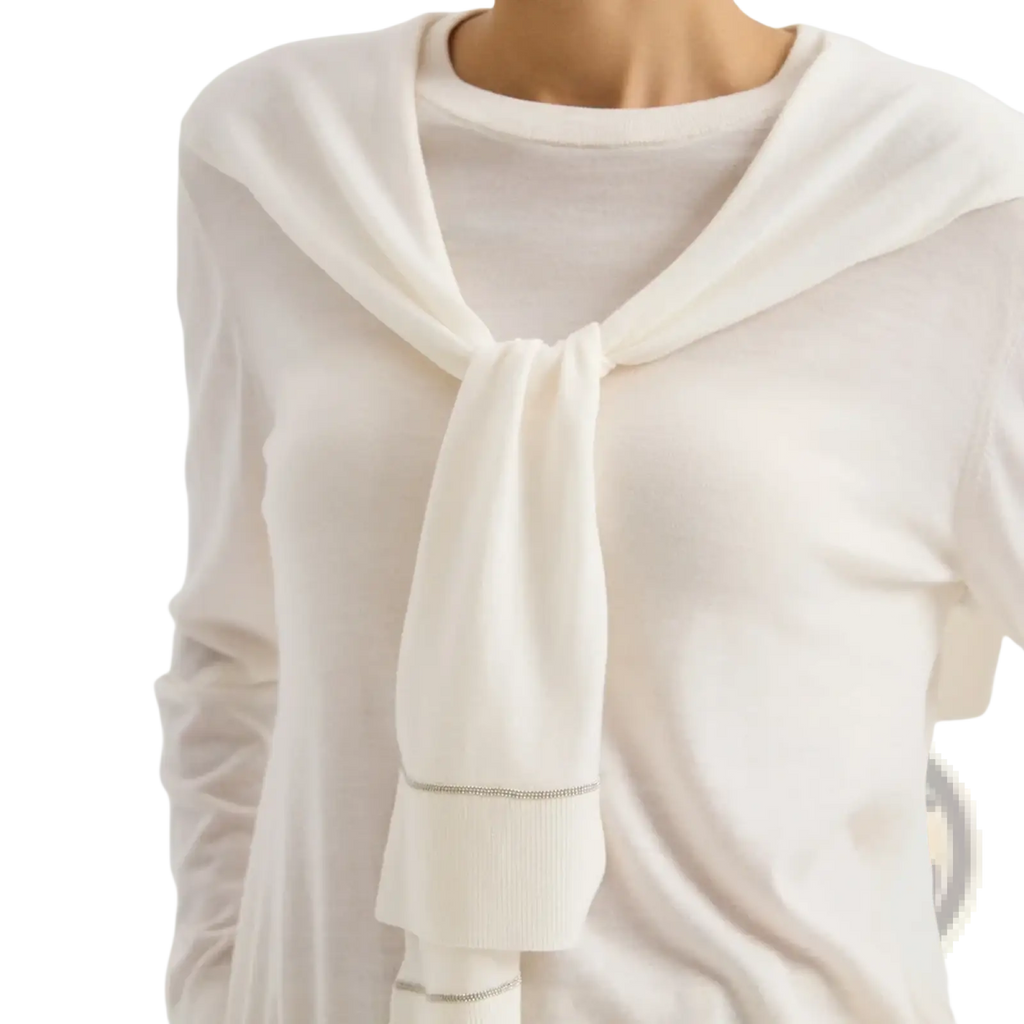 Wool knit shoulder wrap cape scarf in soft white with silver chain hem worn as stylish necktie over matching top