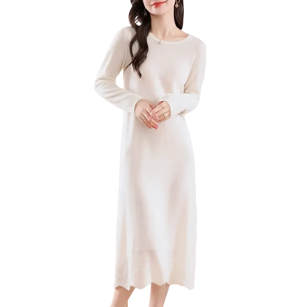 A soft off-white wool knit sweater dress with long sleeves and a scalloped hem in a midi length