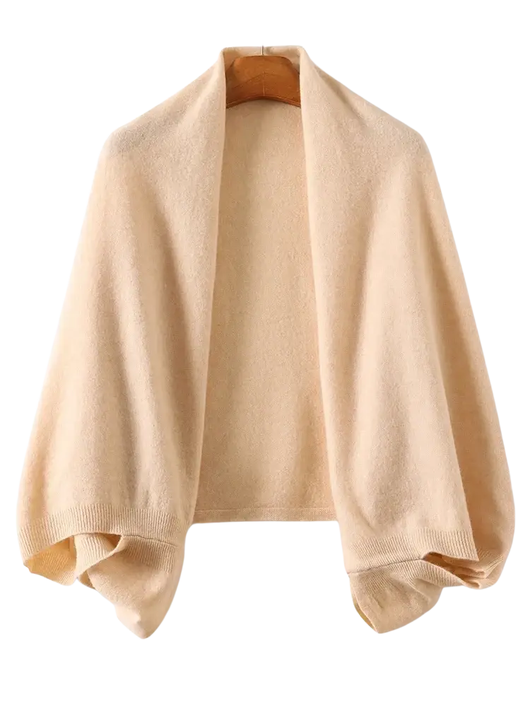 Beige knitted wool shawl wrap scarf for women draped over wooden hanger showcasing its texture and warmth