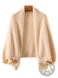 Beige knitted wool shawl wrap scarf for women draped over wooden hanger showcasing its texture and warmth