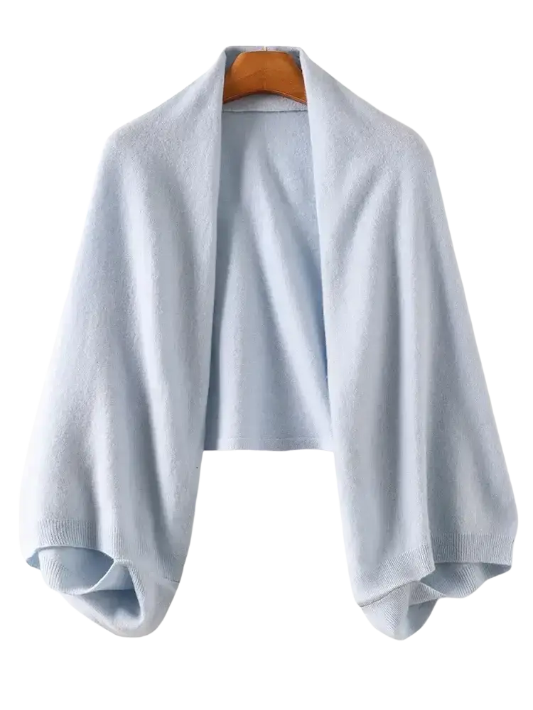 Light blue knitted wool shawl wrap scarf for women with ribbed cuffs and hem displayed on wooden hanger