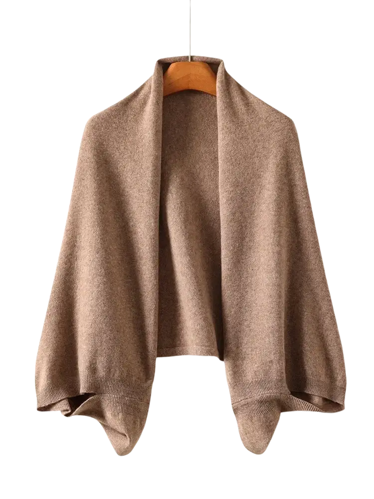 A camel-colored wool shawl wrap scarf for women made of soft cashmere with a cozy knit texture and ribbed cuffs
