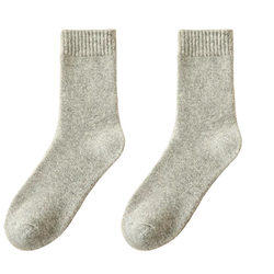 A pair of heather gray wool socks for men with ribbed cuffs made from thick soft knit fabric for winter thermal use