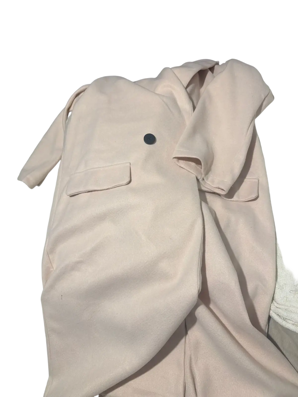 A blush-colored woolen coat for women with a black button and two front pockets ideal for winter outerwear