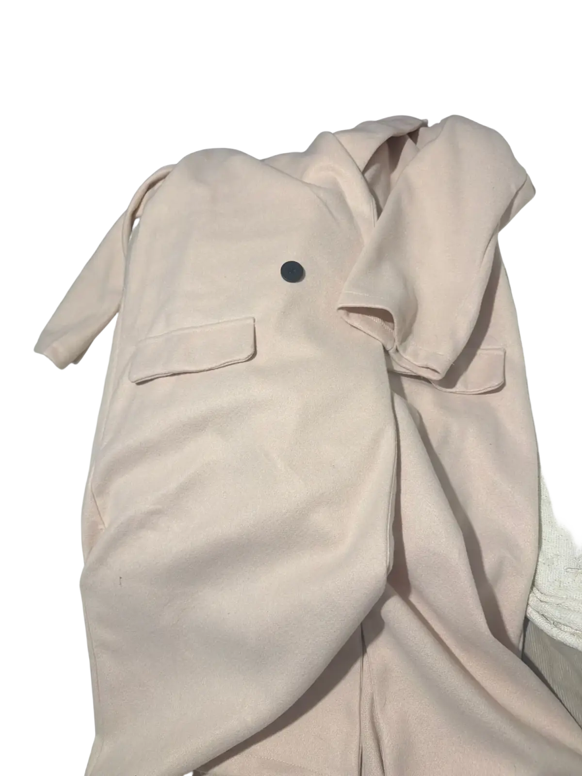 A blush-colored woolen coat for women with a black button and two front pockets ideal for winter outerwear