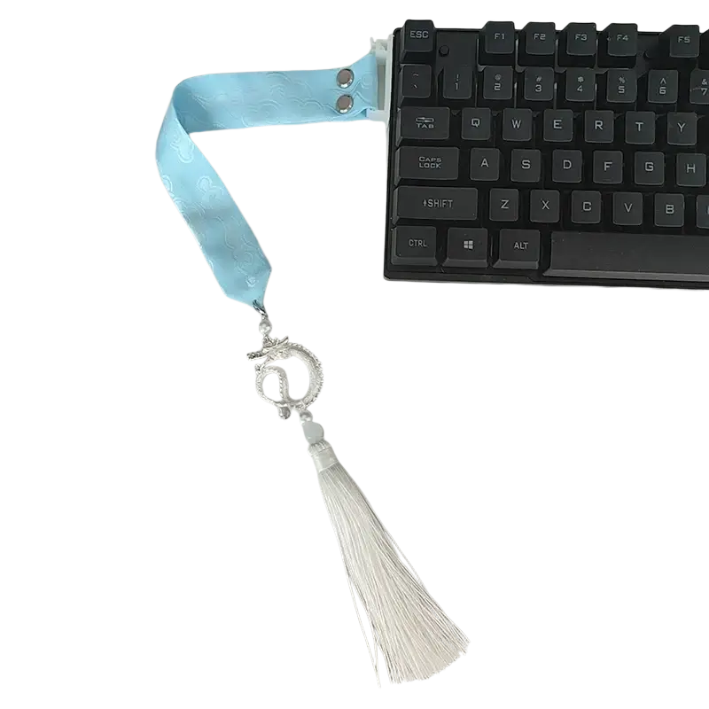 Wooting keyboard ribbon custom strap featuring light blue satin ribbon with silver dragon charm and white tassel attached
