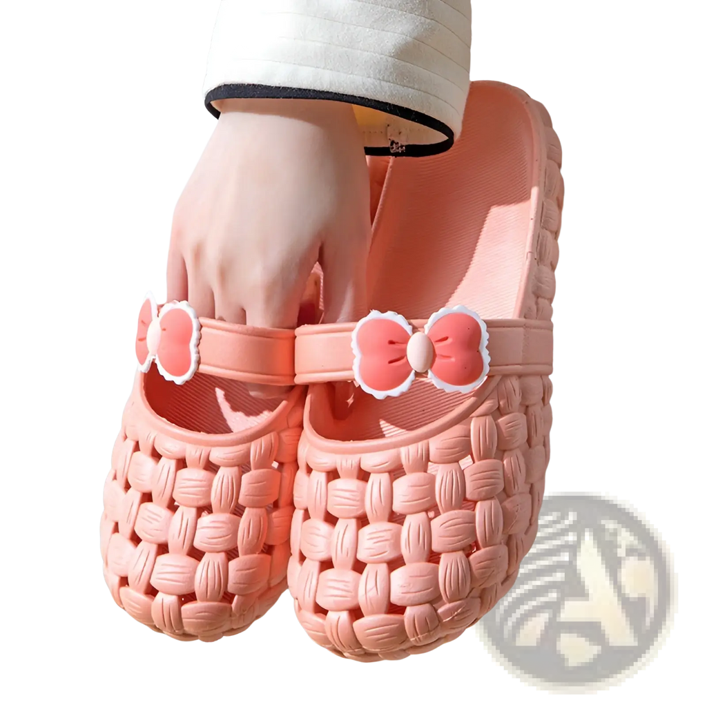 Pink woven plastic slippers with decorative bow straps designed as summer pvc beach slide sandals