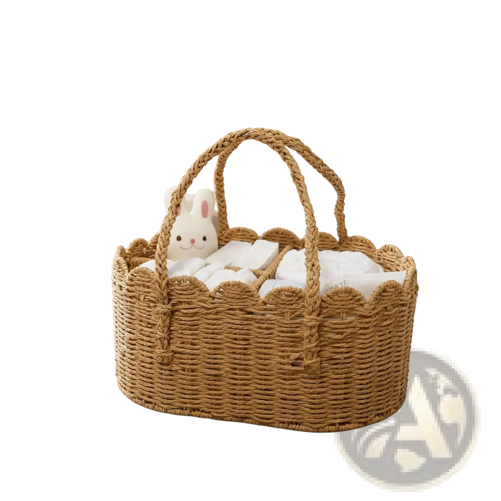 Woven diaper caddy made of natural rattan with scalloped edges and braided handles filled with white linens and plush bunny
