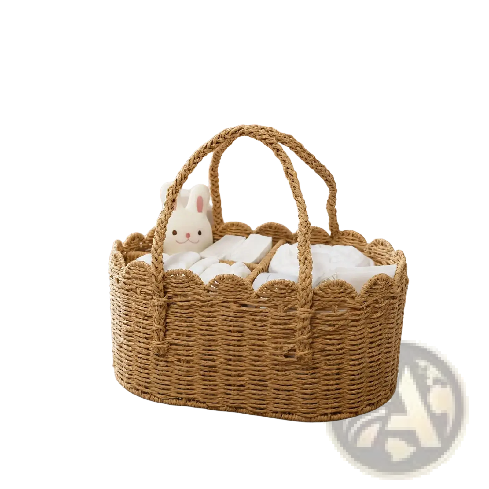 Woven diaper caddy made of natural rattan with scalloped edges and braided handles filled with white linens and plush bunny