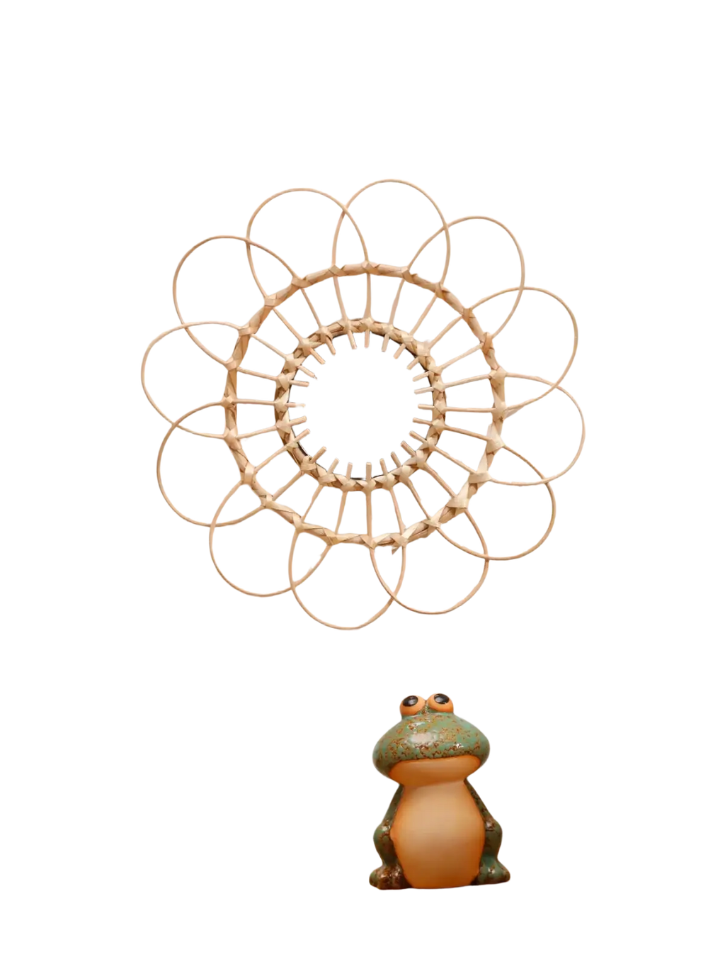 A circular wall mirror with a light-colored woven rattan sunburst frame for room decors aesthetic and style