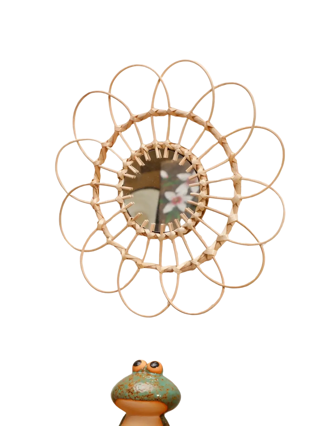 A circular wall mirror with a light beige woven rattan sunburst frame enhances room decors aesthetic