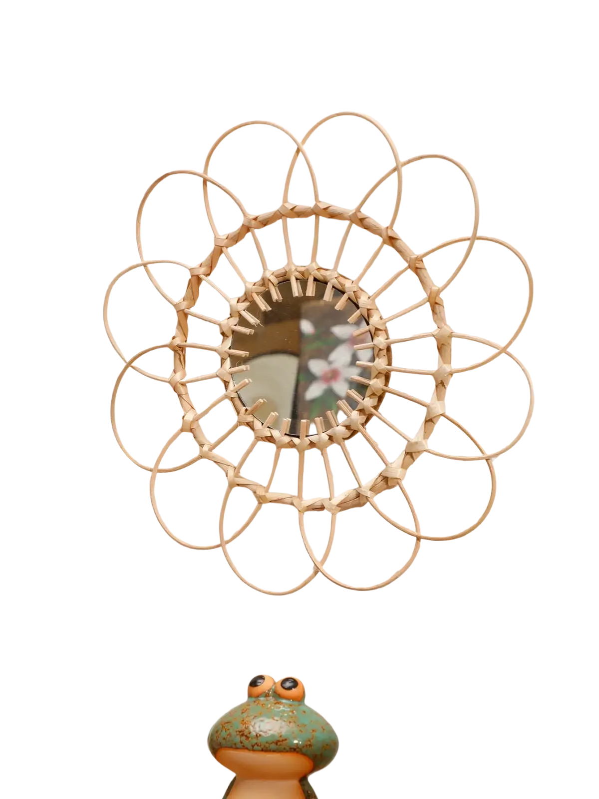 A circular wall mirror with a light beige woven rattan sunburst frame enhances room decors aesthetic