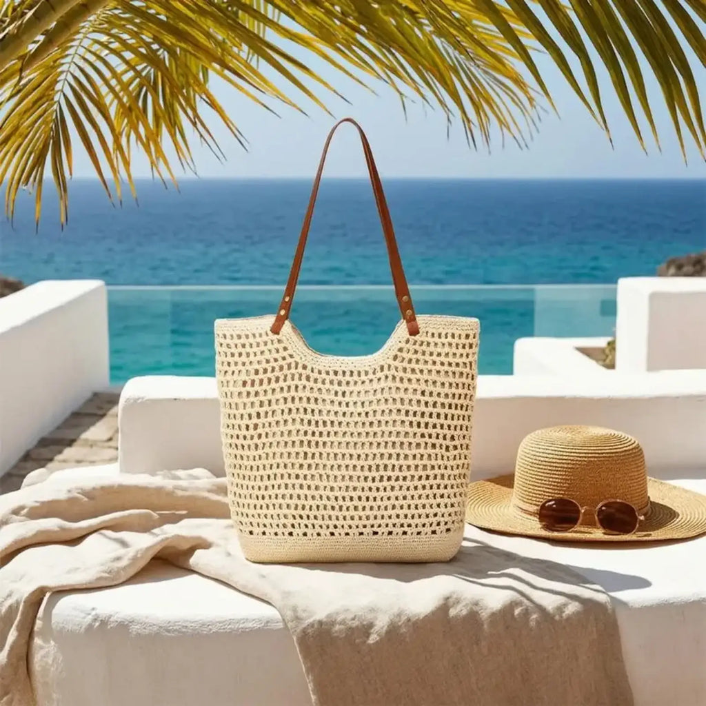Beige woven straw tote bag with large capacity and brown leather handles perfect for summer beach use