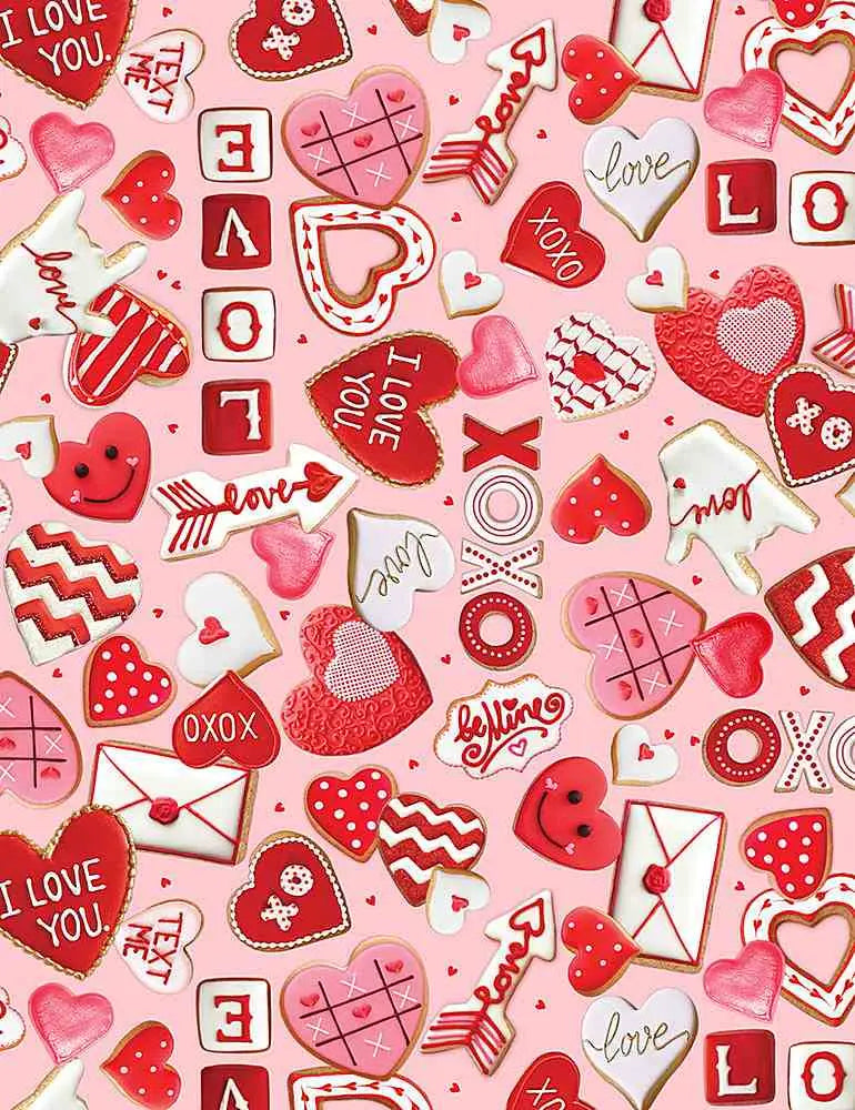 Pink and red valentine themed cookie cutouts with hearts arrows i love you and xoxo designs for festive occasions