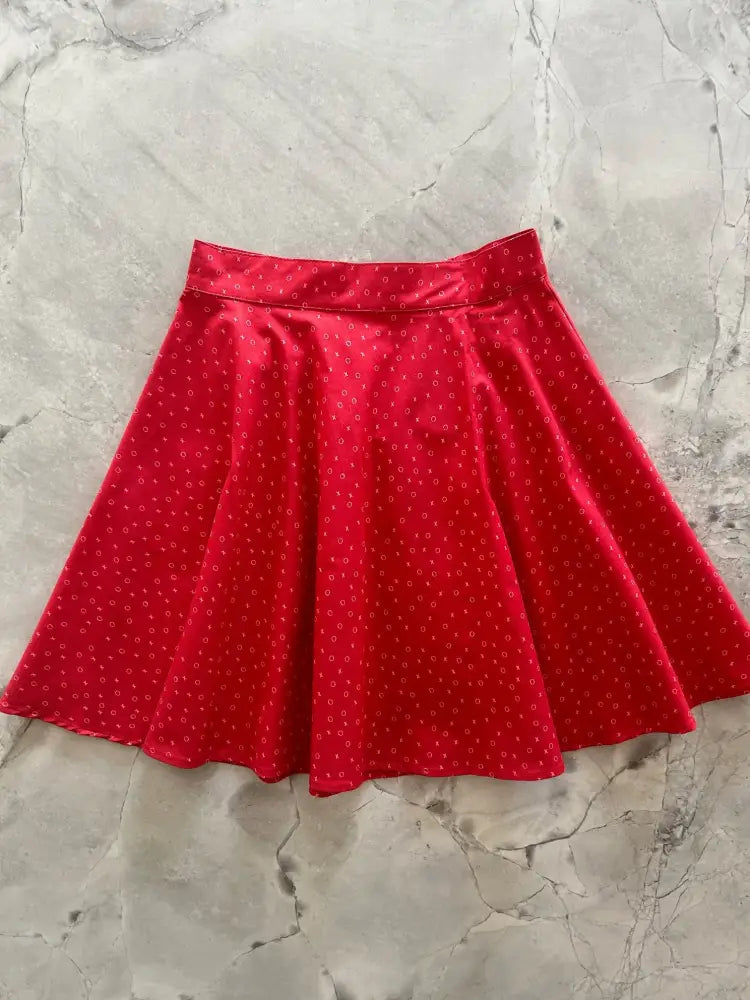 Red polka-dot flared skirt with satin-like finish featuring elastic waist in xoxo print red cotton skater skirt style