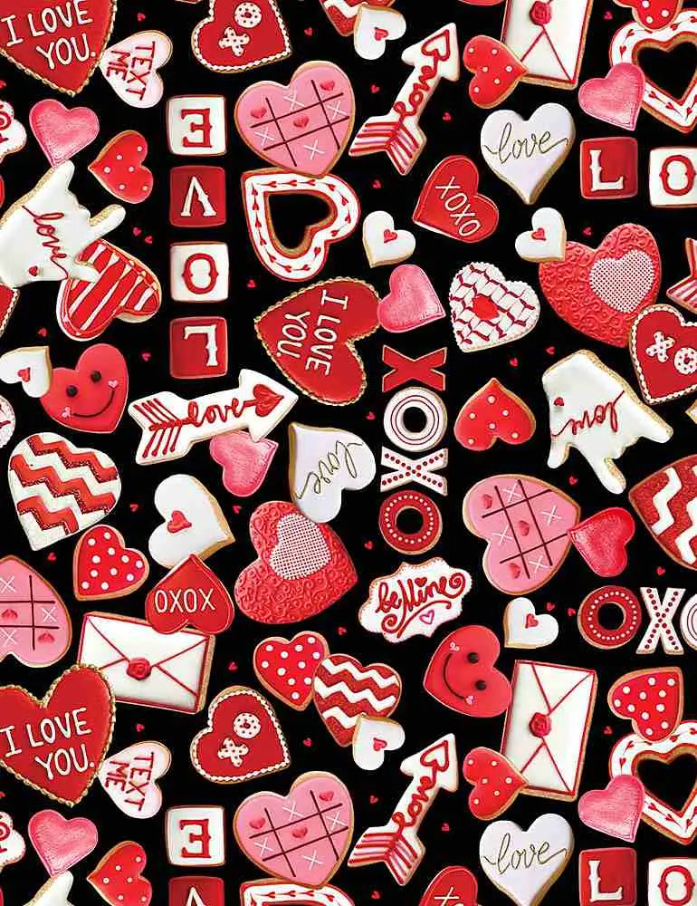 Red and white valentine’s day-themed sugar cookies styled with an xoxo heart print vintage 1950s cotton sleeveless dress