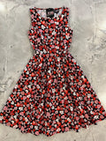 A sleeveless black cotton dress with vibrant red, pink, and white heart and love note vintage 1950s print