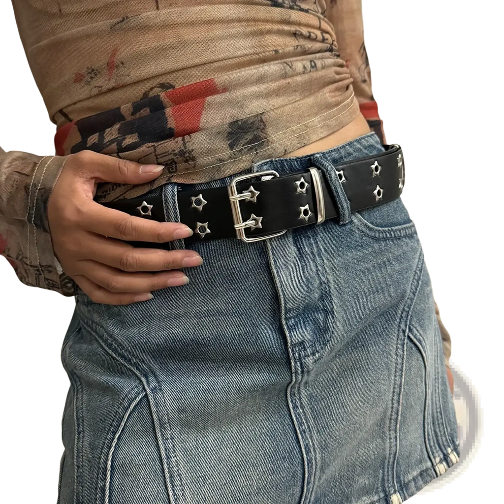 Black leather Y2k double grommet punk belt with silver star-shaped studs and a rectangular buckle
