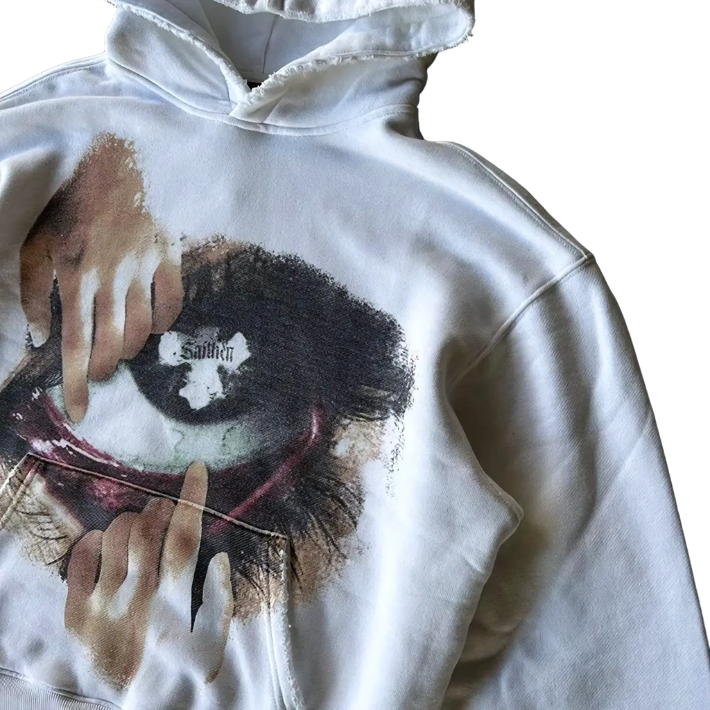 White oversized hoodie with dark earthy brown graphic of an eye and reaching hands printed on the front