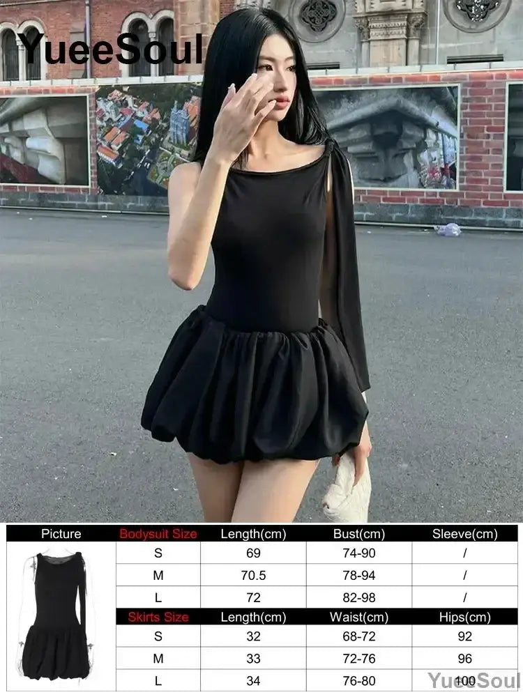 Black one-shoulder pleated mini bodysuit with long sleeve and ruffled skirt featuring a secure closure type detail