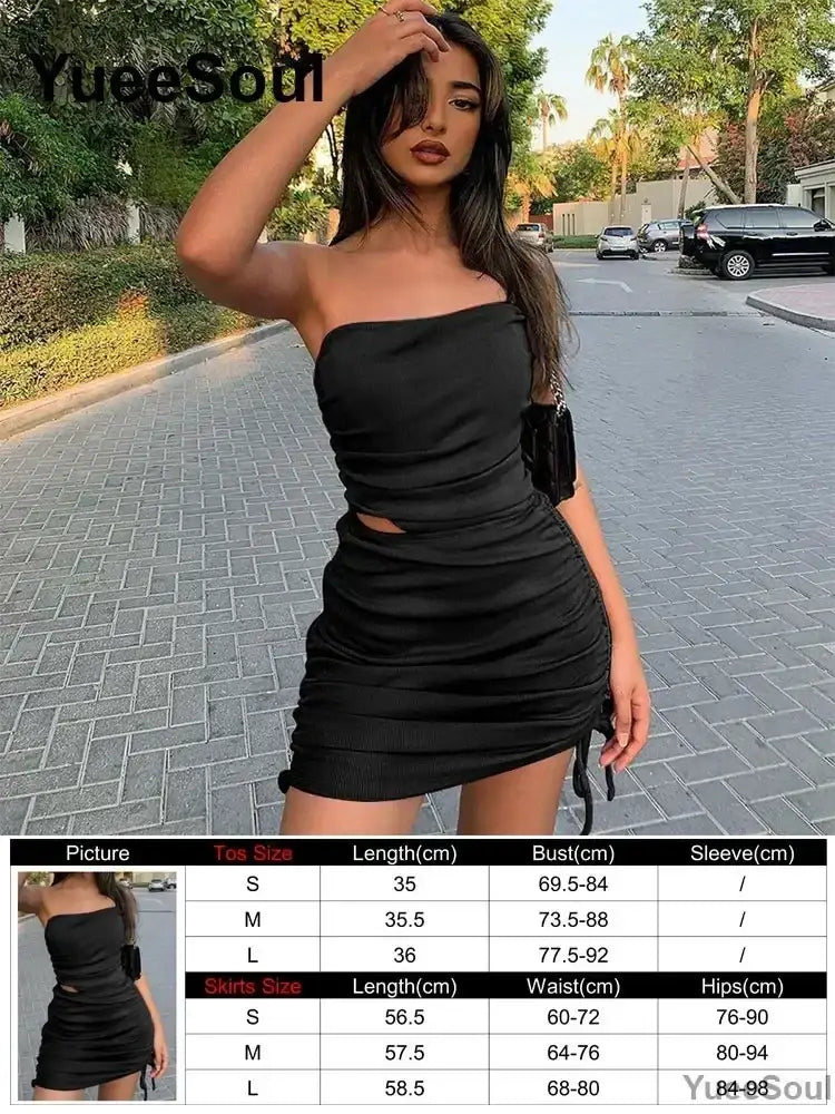 Black strapless ruched mini dress with side cutouts and drawstring waistband featuring adjustable closure type