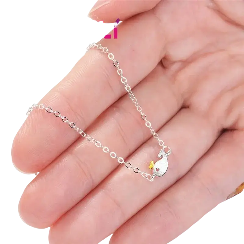 Yaameli sterling silver cubic zirconia whale bracelet with a delicate chain and shiny fish charm with yellow fin and red eye